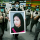 A portrait of 35-year-old doctor Tse Yuen-man who died from SARS virus is carried during her funeral in Hong Kong May 22, 2003. Tse, the first front-line doctor to be killed by the disease in the territory, was given the highest honours at her funeral and was buried in Gallant Garden, a cemetary reserved for residents who perish in the line of duty. The deadly virus has infected 1,719 people and killed 255 since it swept into the congested territory.